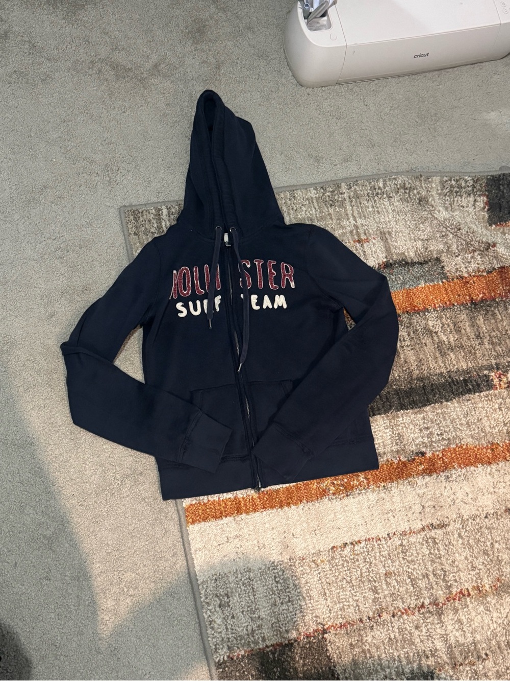 Hollister Navy Zip-Up Hoodie with Red & White Logo